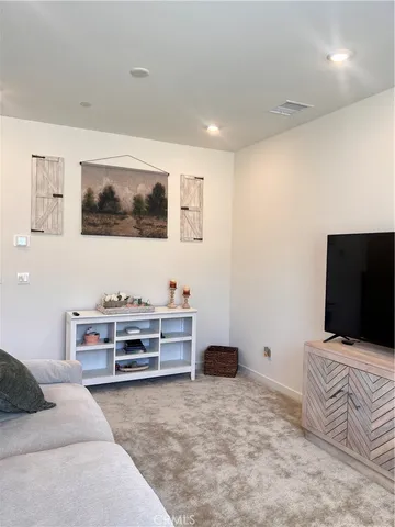 a bedroom with furniture and flat screen tv