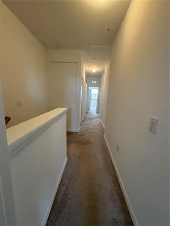 an empty room with a window and a ceiling fan