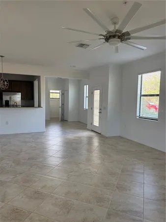 a view of a livingroom with a ceiling fan and window