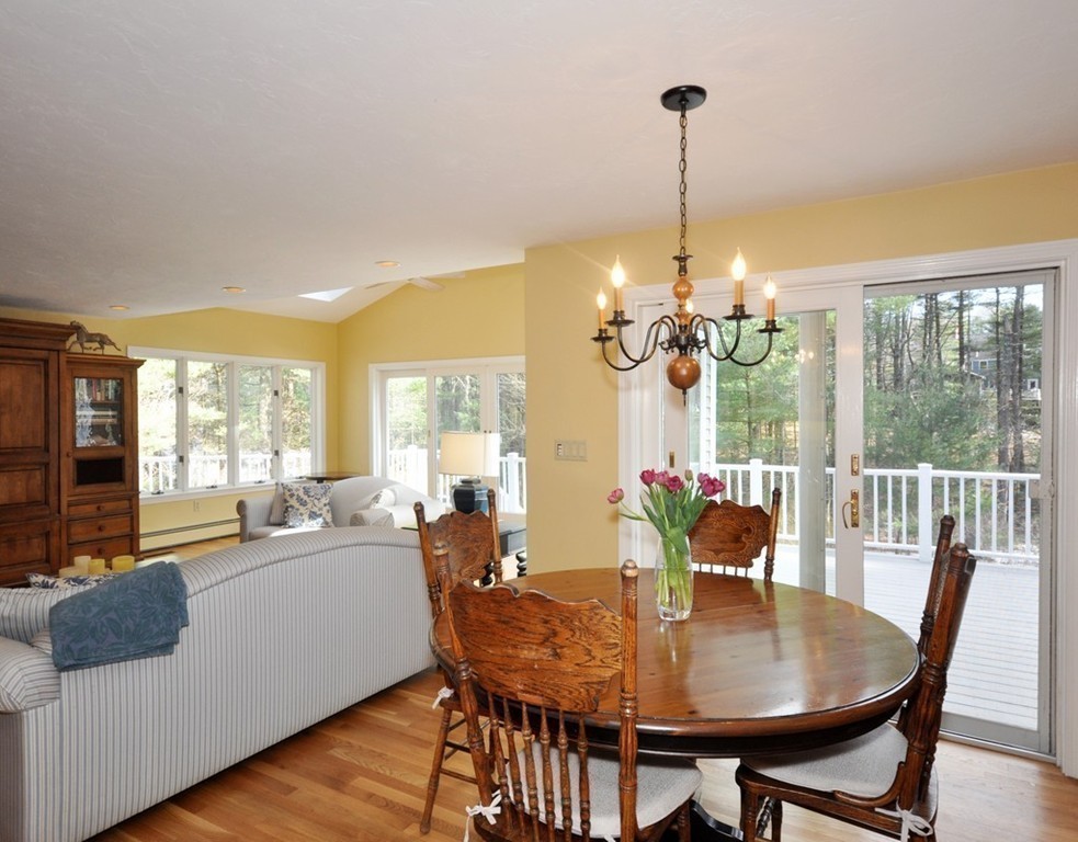 1055 Old Marlboro Road Concord, MA 01742 - Photo 9 of 19 a view of a dining room with furniture wooden floor and chandelier