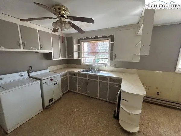 a utility room with cabinets washer and dryer