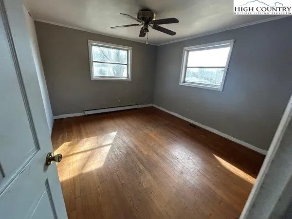 a view of a room with an empty space and a window