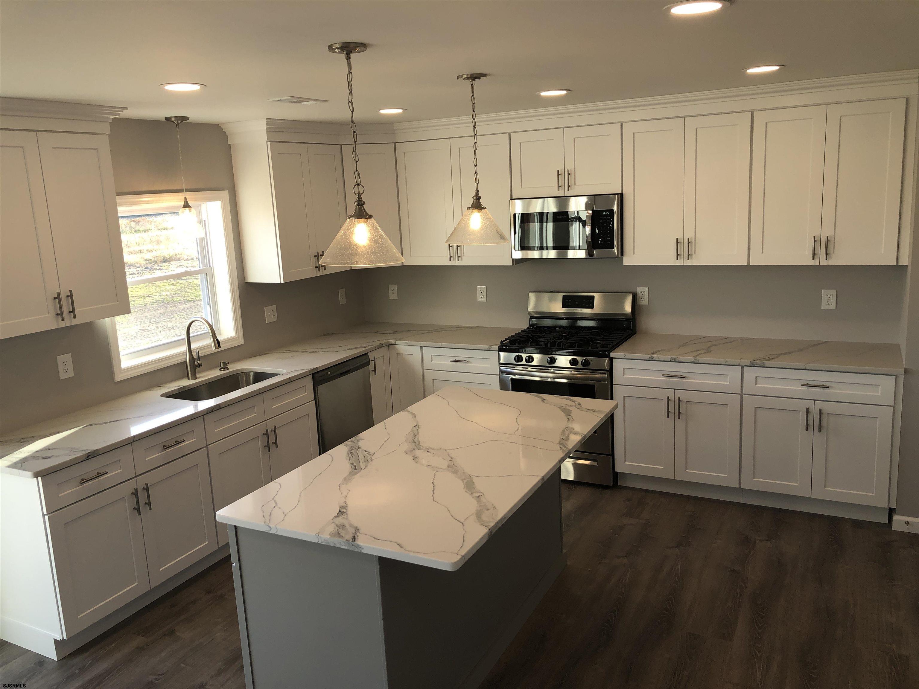 105 Wheat Road Vineland, NJ 08360 - Photo 11 of 30 a kitchen with a sink a stove a refrigerator and white cabinets