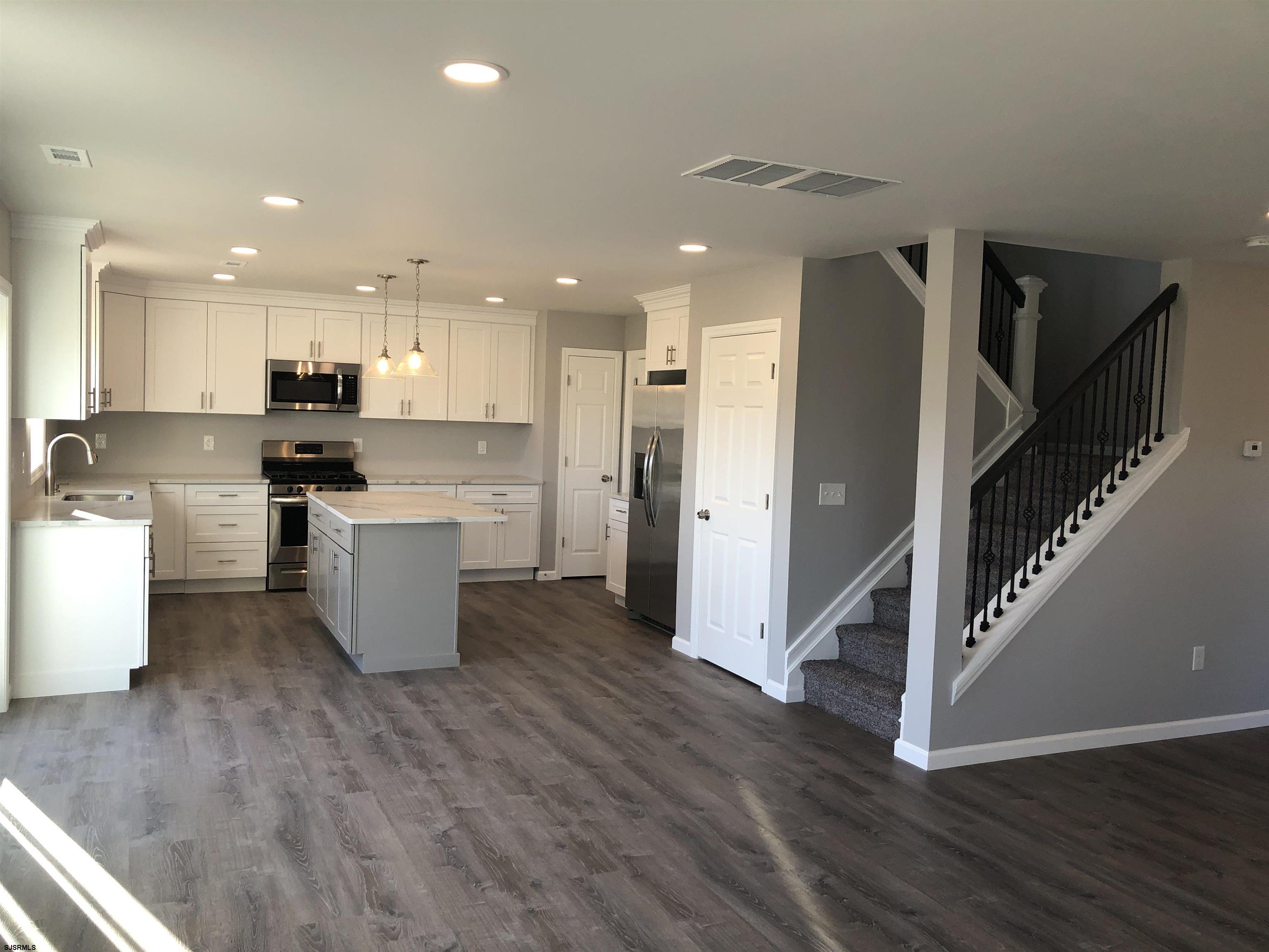 105 Wheat Road Vineland, NJ 08360 - Photo 12 of 30 a large kitchen with cabinets a counter top space stainless steel appliances and a ceiling fan