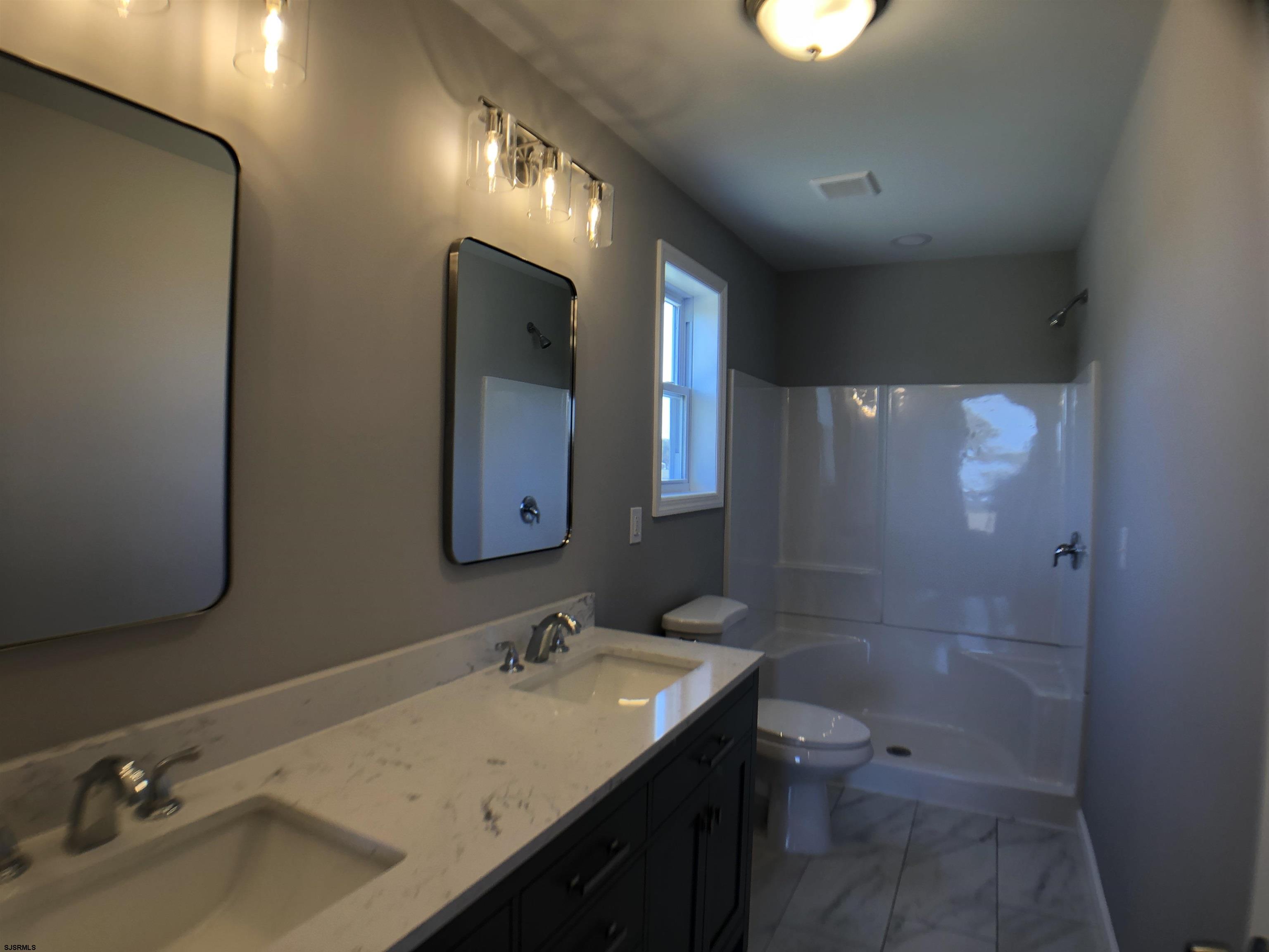 105 Wheat Road Vineland, NJ 08360 - Photo 18 of 30 a bathroom with a sink and a mirror
