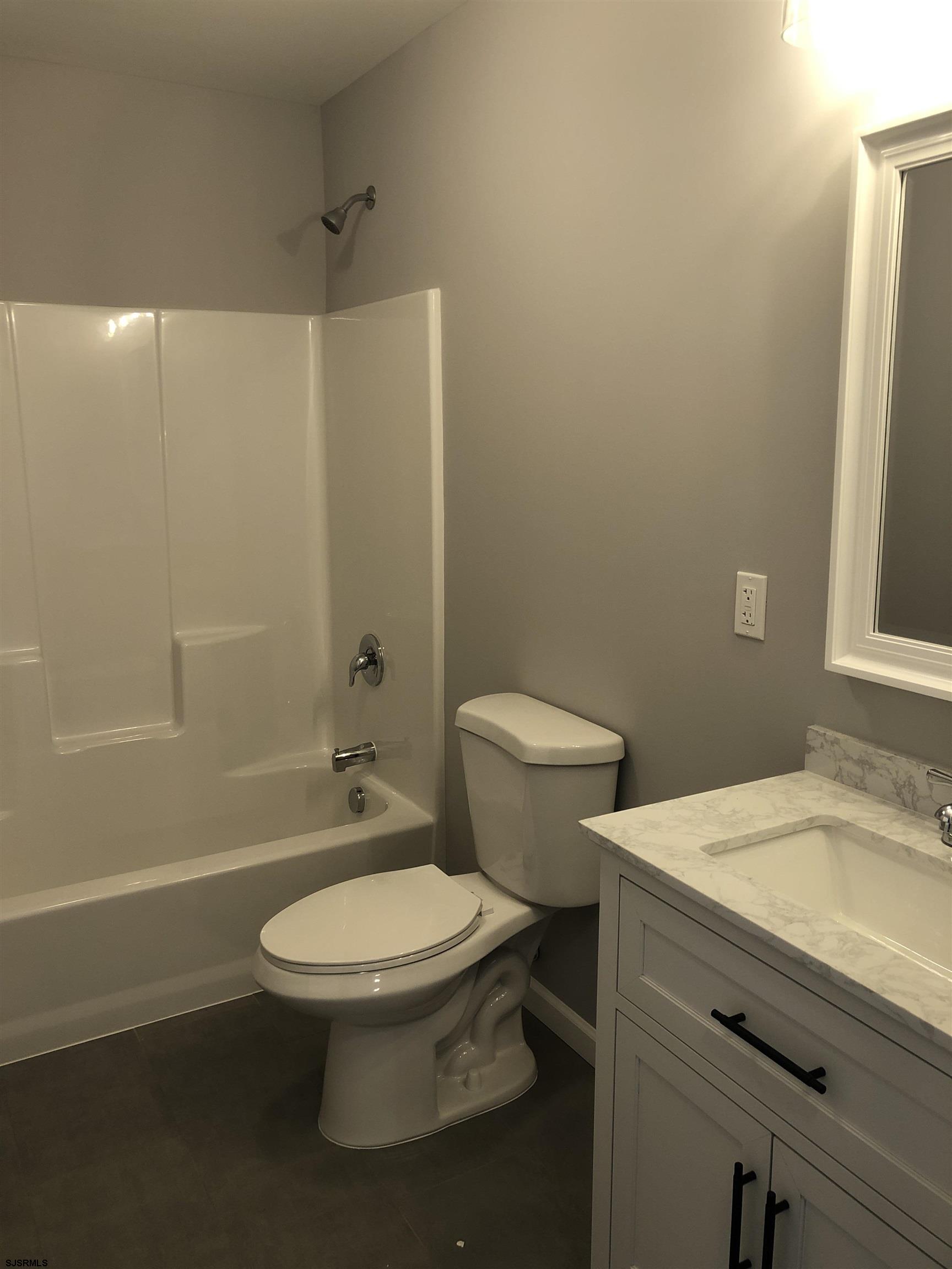 105 Wheat Road Vineland, NJ 08360 - Photo 22 of 30 a bathroom with a granite countertop toilet a sink and a mirror