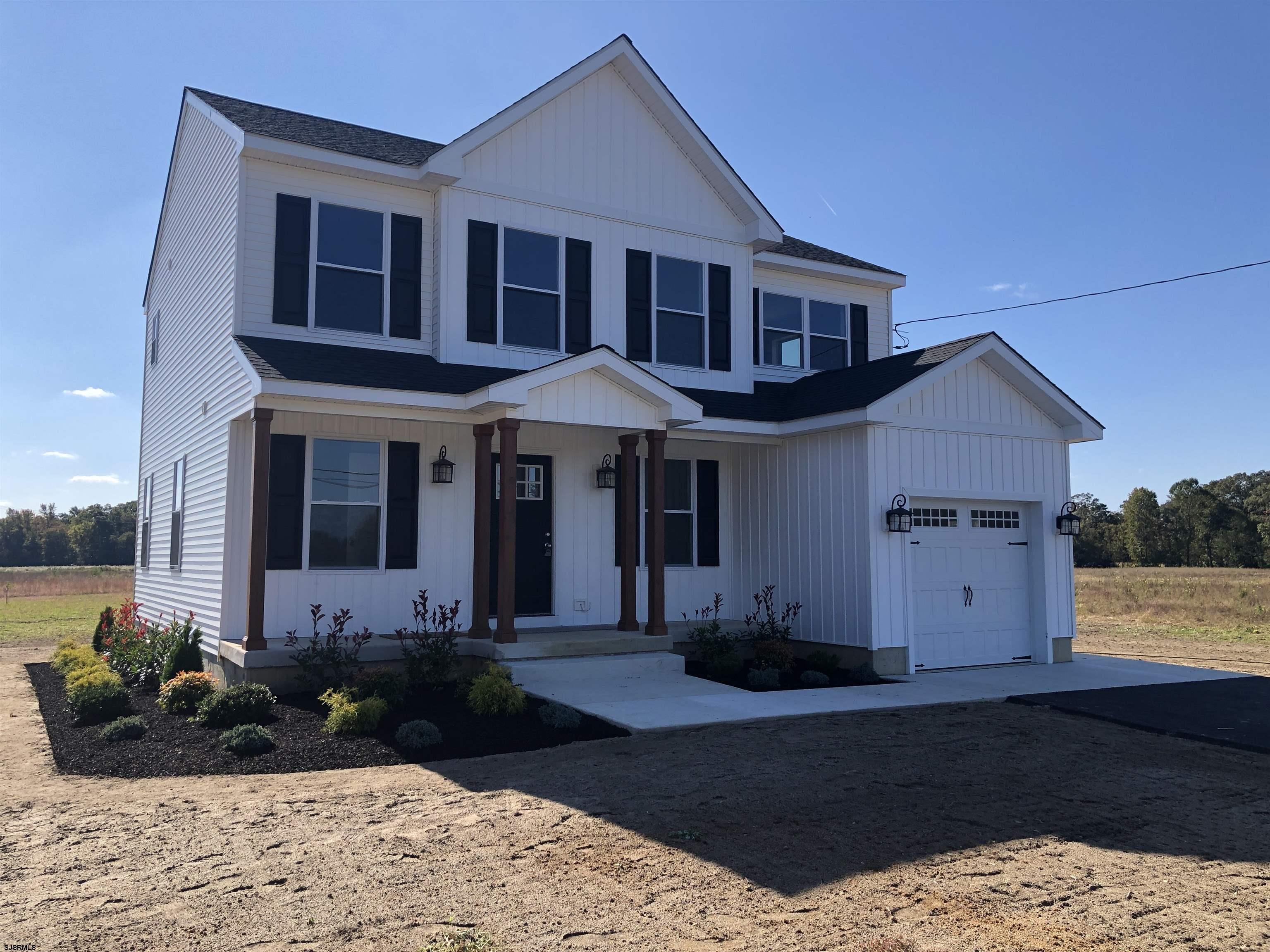 105 Wheat Road Vineland, NJ 08360 - Photo 30 of 30 a front view of a house with a yard outdoor seating and covered with trees
