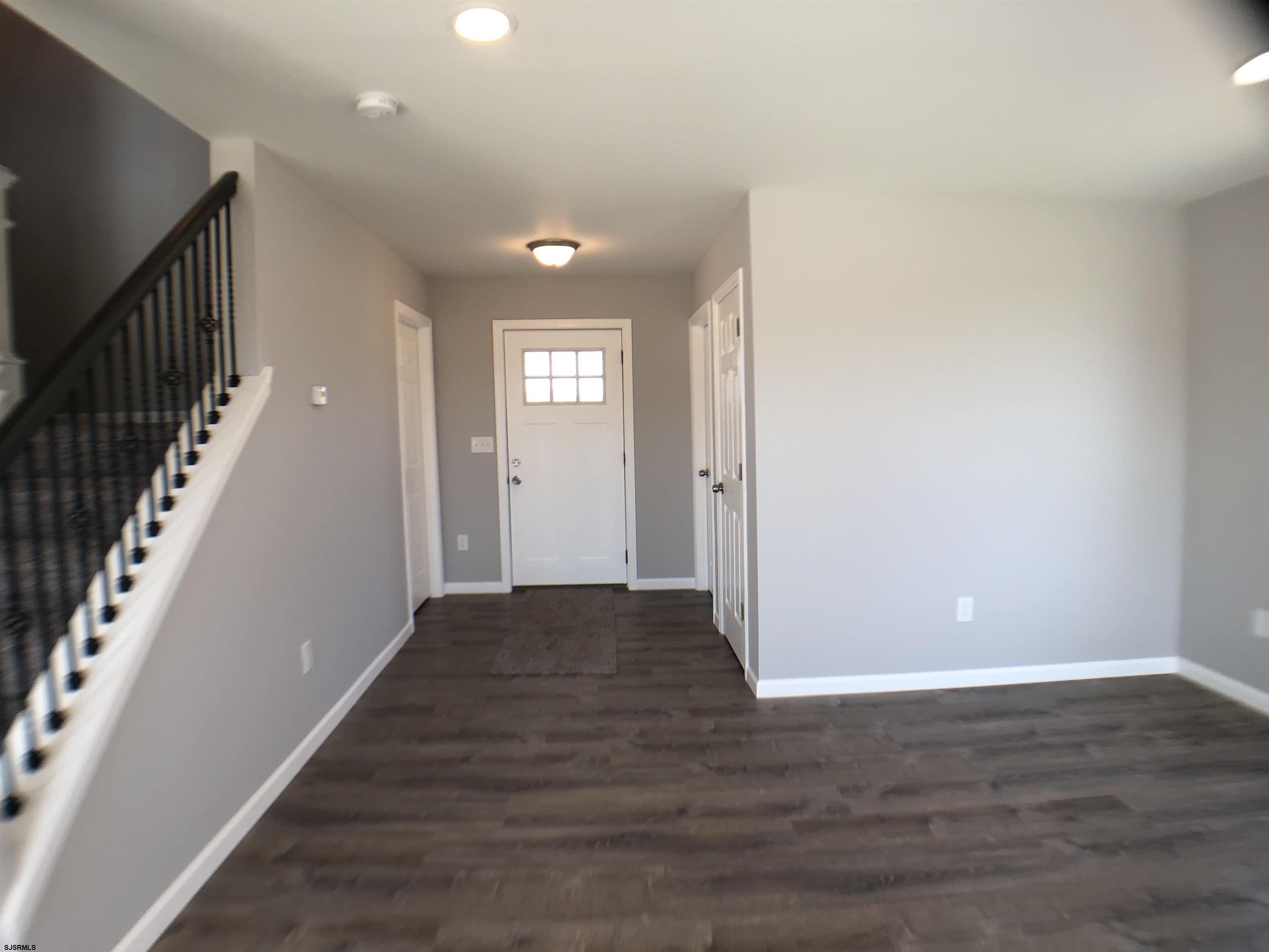 105 Wheat Road Vineland, NJ 08360 - Photo 7 of 30 a view of a hallway with wooden floor and staircase