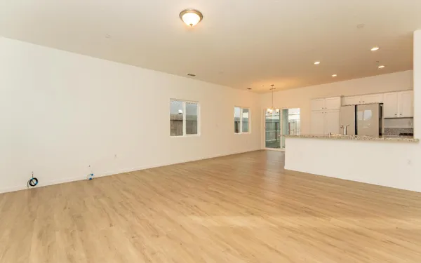 a view of an empty room with wooden floor