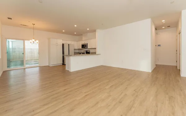a view of a kitchen with a sink and a refrigerator