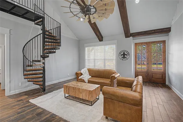 a living room with furniture and wooden floor