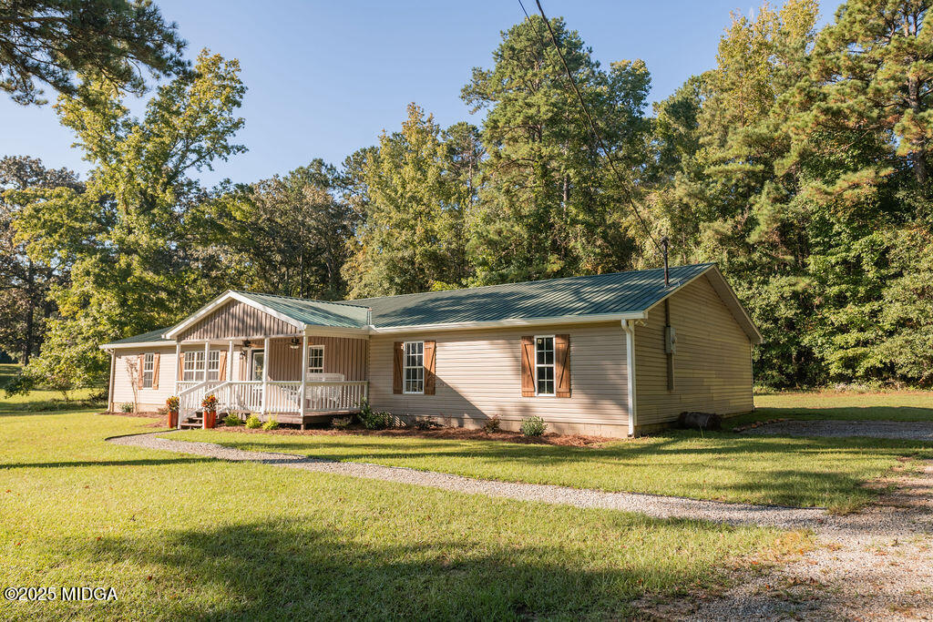 12820 Highway 87 Juliette, GA 31046 - Photo 2 of 57 a front view of a house with a garden and trees