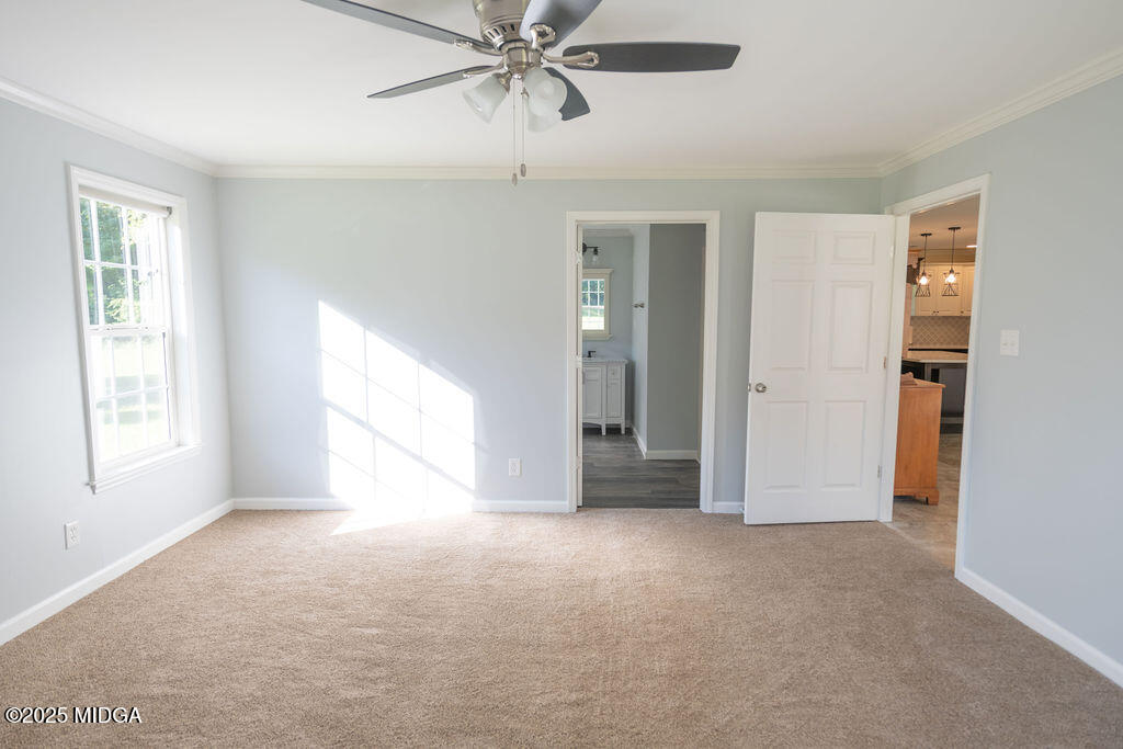 12820 Highway 87 Juliette, GA 31046 - Photo 24 of 57 a view of an empty room with chandelier fan and fire place