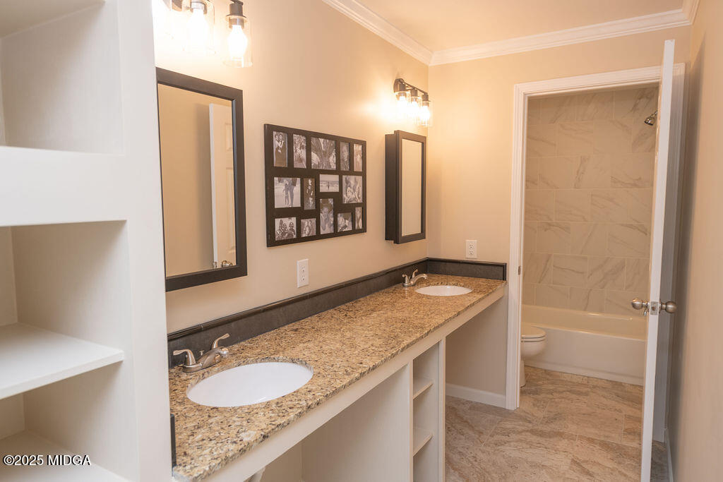 12820 Highway 87 Juliette, GA 31046 - Photo 32 of 57 a bathroom with a granite countertop sink a mirror and shower