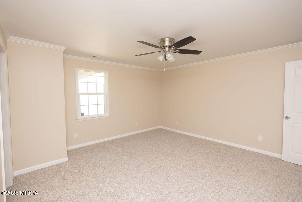 12820 Highway 87 Juliette, GA 31046 - Photo 38 of 57 an empty room with a window and a fan