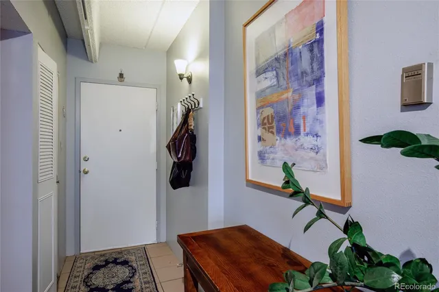 a bedroom with a table and a potted plant