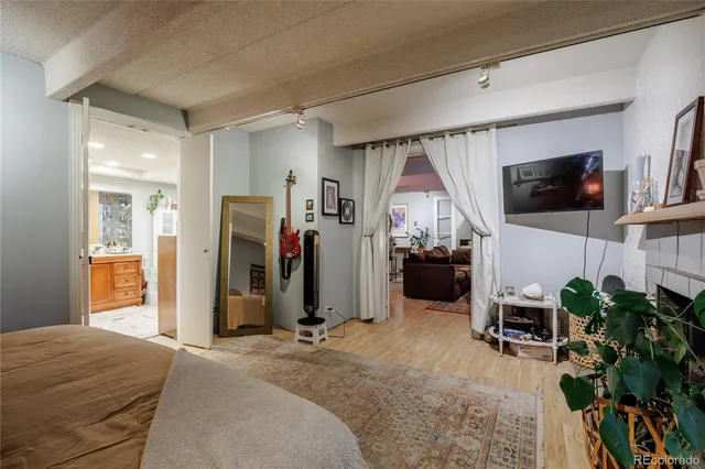 a bedroom with furniture and a flat screen tv
