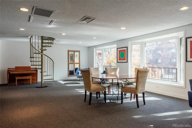a living room with furniture a fireplace and a large mirror with potted plants