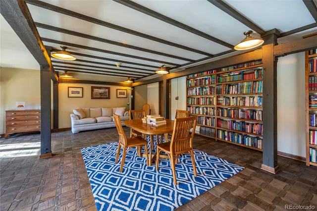 a living room with furniture and a book shelf