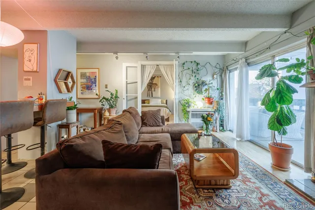 a living room with furniture and a large window