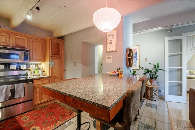a kitchen with stainless steel appliances granite countertop a stove top oven a sink a counter space and cabinets