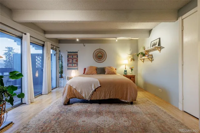 a bedroom with a bed and a potted plant