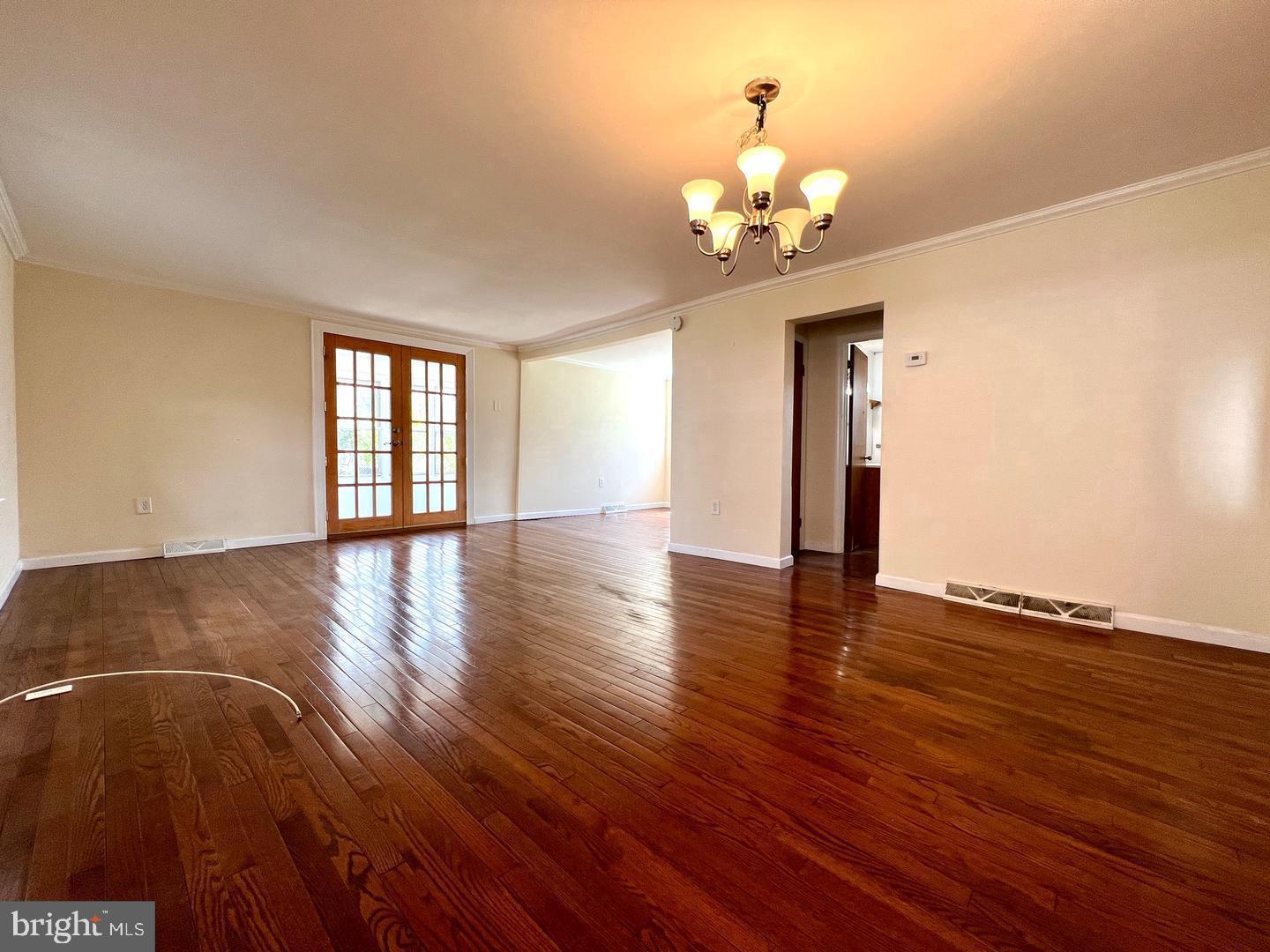 27 Rancocas Avenue Clementon, NJ 08021 - Photo 3 of 16 a view of an empty room with wooden floor and a window