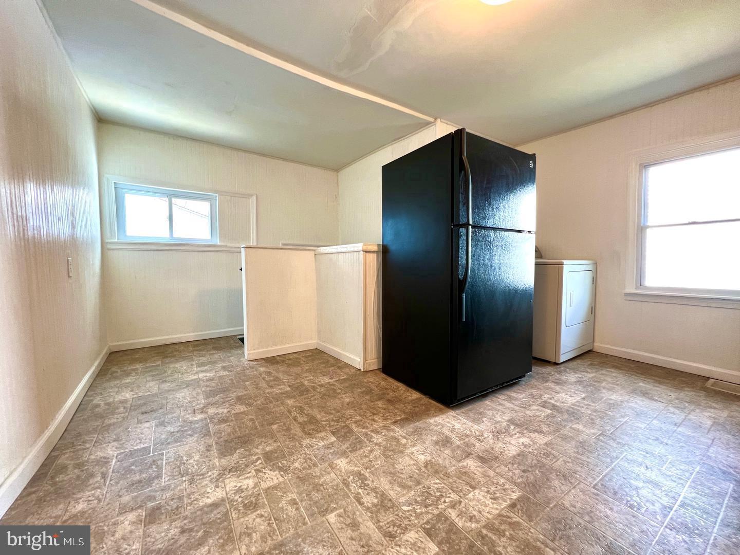 27 Rancocas Avenue Clementon, NJ 08021 - Photo 5 of 16 a view of an empty room with window and refrigerator