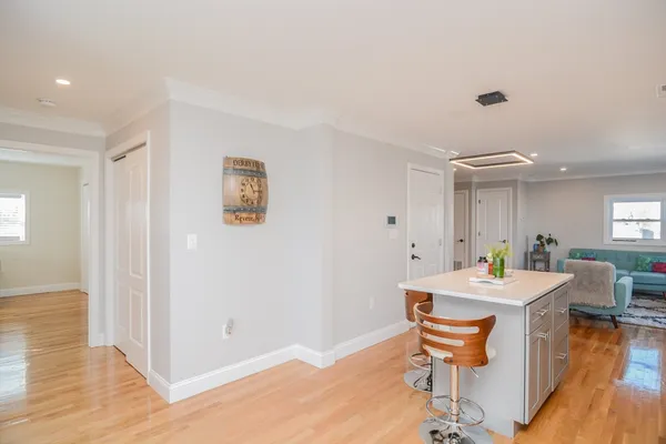 a room with a table chairs and wooden floor
