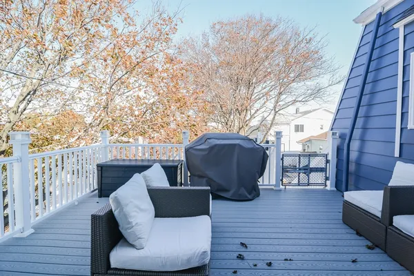 a view of a couches in the deck with wooden floor