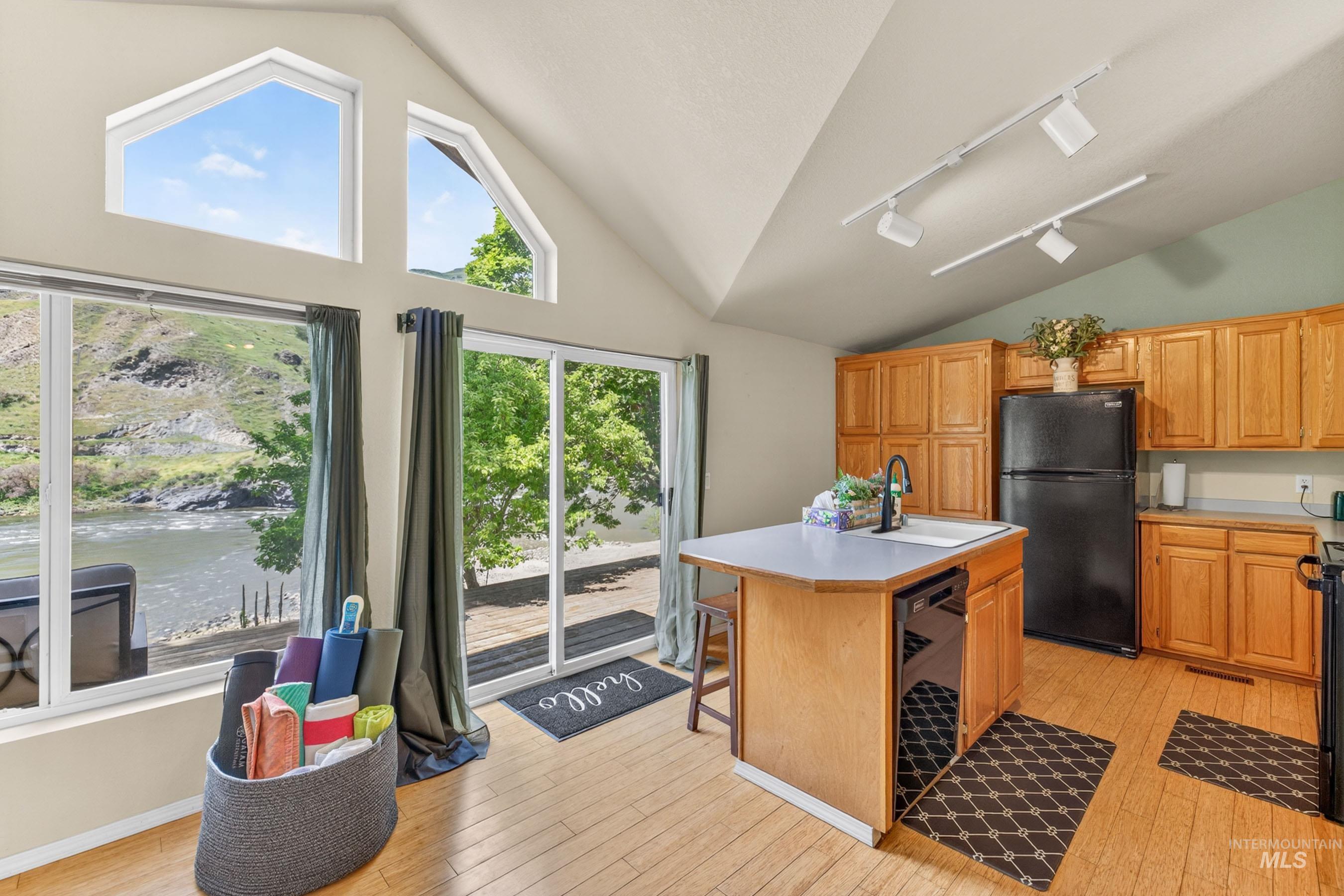 151 Cow Creek Road Lucile, ID 83542 - Photo 15 of 50 Vaulted ceilings featuring multiple windows and a sliding glass door