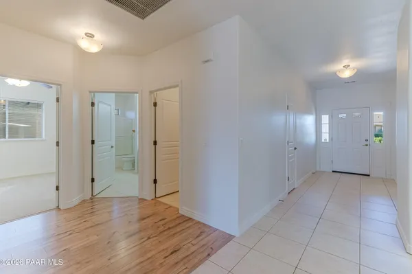 a kitchen with a dining table chairs and large windows