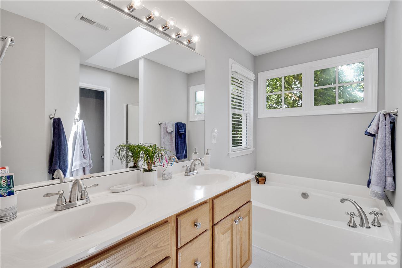 10228 River Bank Drive Raleigh, NC 27614 - Photo 13 of 29 a bathroom with a tub a sink and a mirror