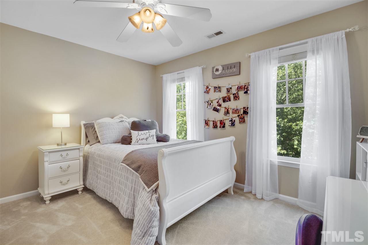 10228 River Bank Drive Raleigh, NC 27614 - Photo 17 of 29 a bed room with a bed and a large window