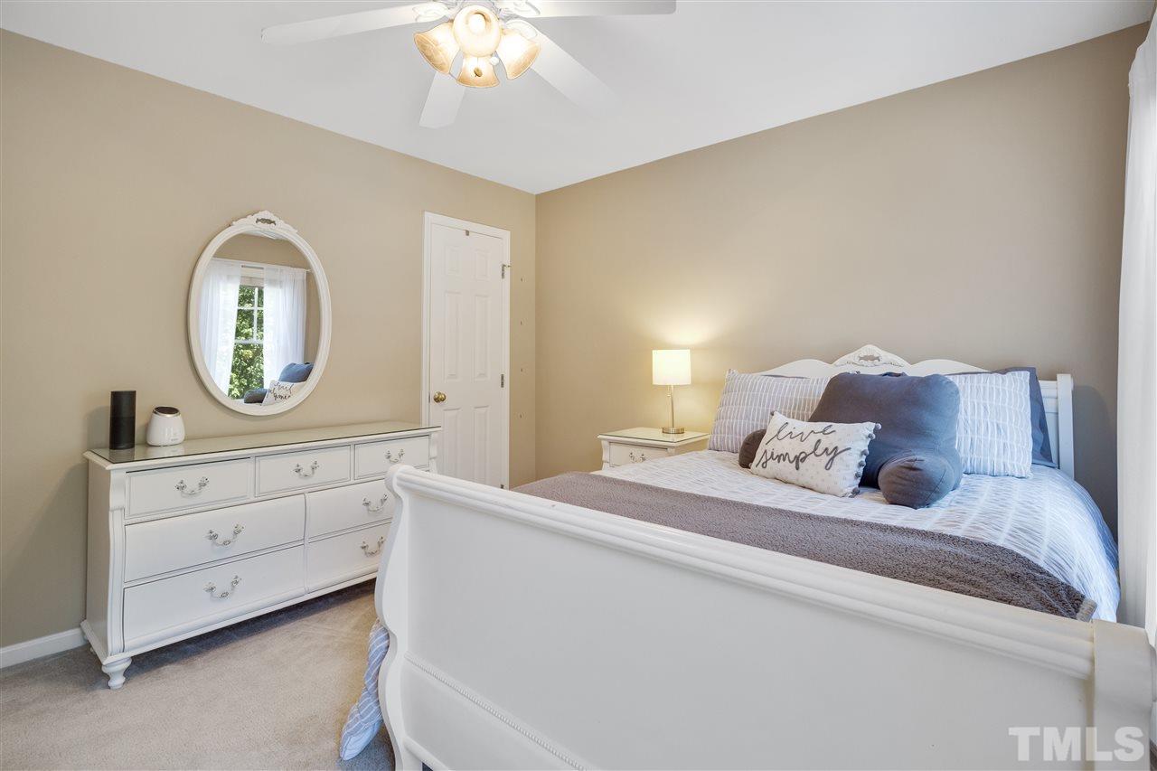 10228 River Bank Drive Raleigh, NC 27614 - Photo 18 of 29 a bedroom with a bed and a dresser