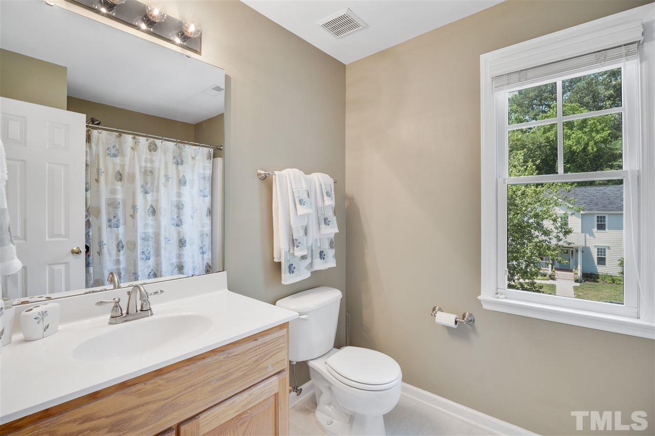 10228 River Bank Drive Raleigh, NC 27614 - Photo 19 of 29 a bathroom with a granite countertop sink toilet and mirror