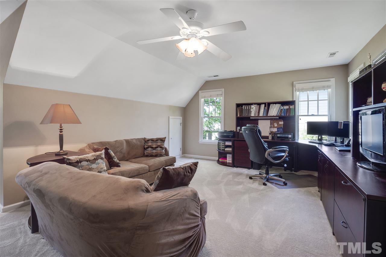 10228 River Bank Drive Raleigh, NC 27614 - Photo 20 of 29 a living room with furniture a large window and a flat screen tv