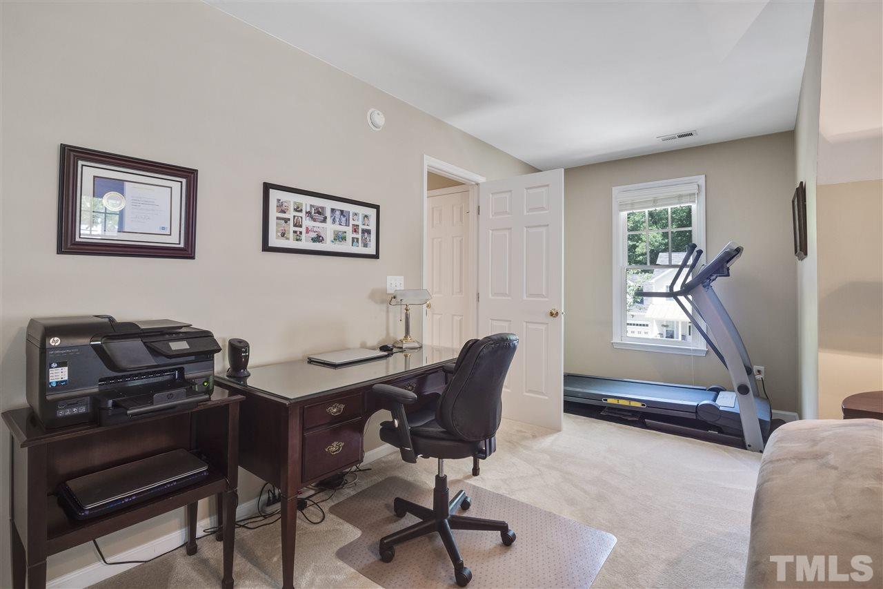 10228 River Bank Drive Raleigh, NC 27614 - Photo 22 of 29 a view of a workspace with furniture and a window