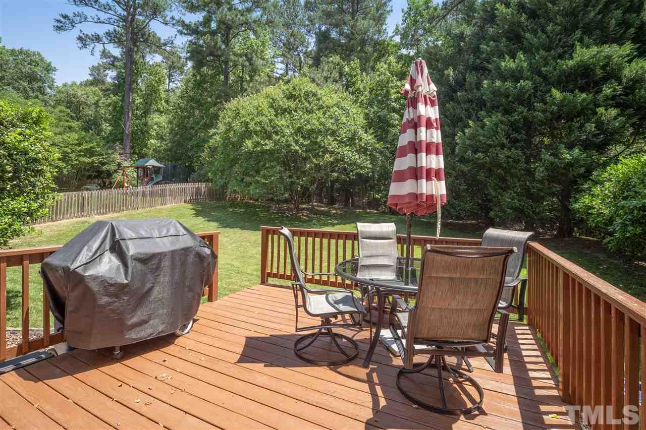 10228 River Bank Drive Raleigh, NC 27614 - Photo 23 of 29 a view of deck with furniture and trees