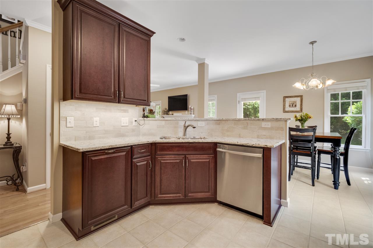 10228 River Bank Drive Raleigh, NC 27614 - Photo 4 of 29 a kitchen with a sink cabinets and wooden floor