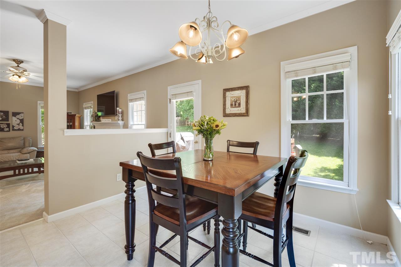 10228 River Bank Drive Raleigh, NC 27614 - Photo 7 of 29 a view of a dining room with furniture and chandelier