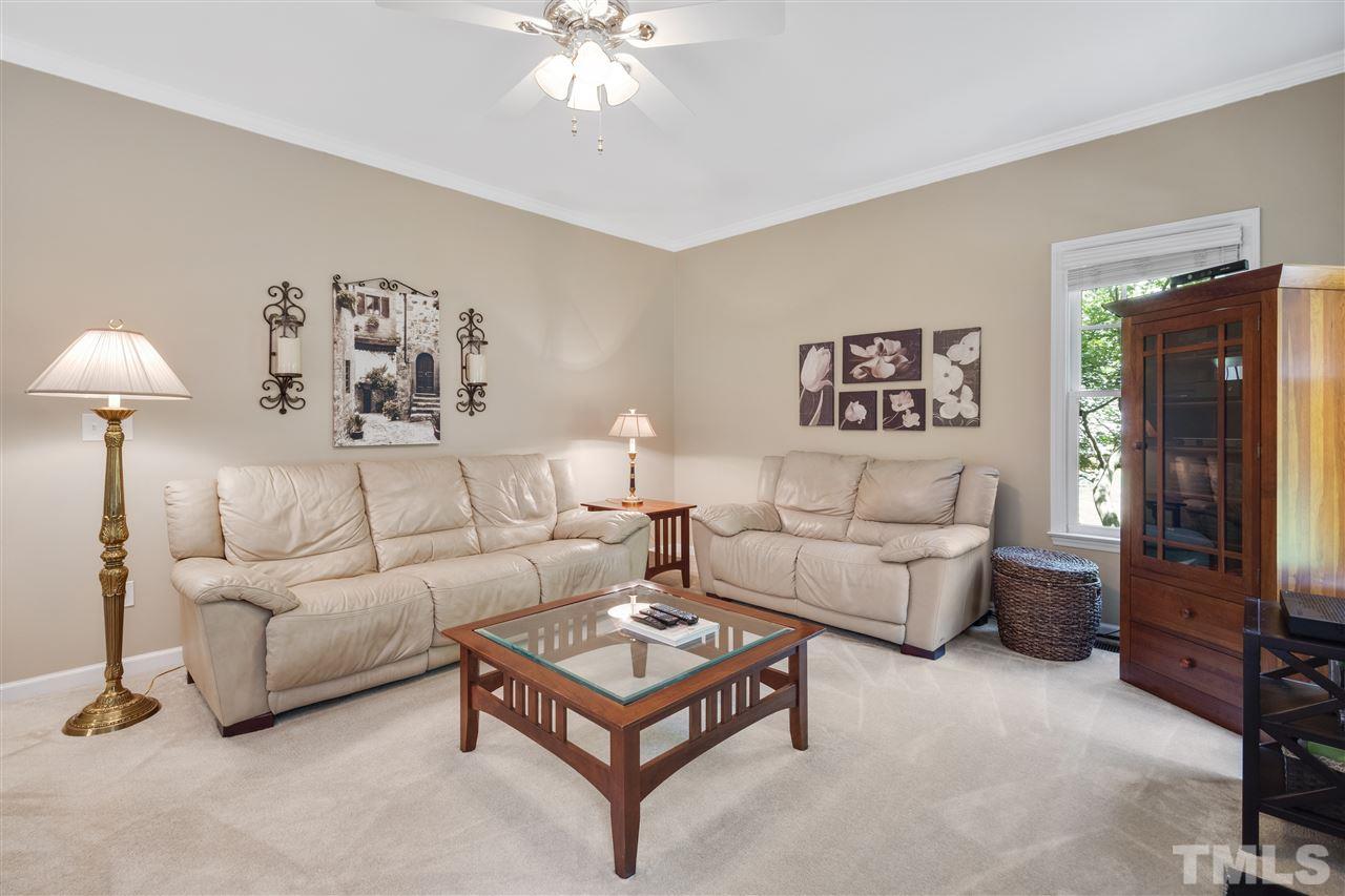 10228 River Bank Drive Raleigh, NC 27614 - Photo 9 of 29 a living room with furniture and a chandelier