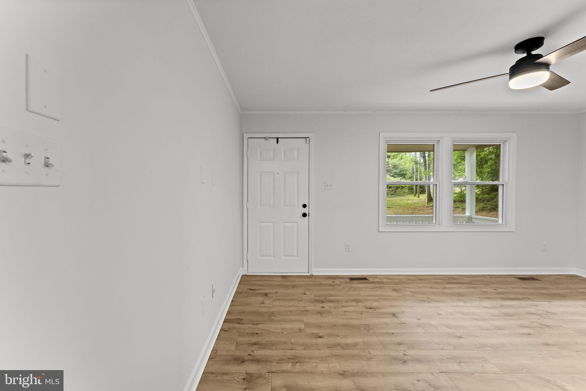 1821 James City Road Reva, VA 22735 - Photo 10 of 44 wooden floor in an empty room with a window