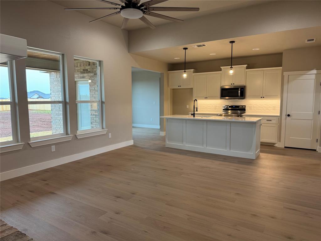 143 Ridge Road Tuscola, TX 79562 - Photo 4 of 24 a view of a kitchen with a sink and a large window