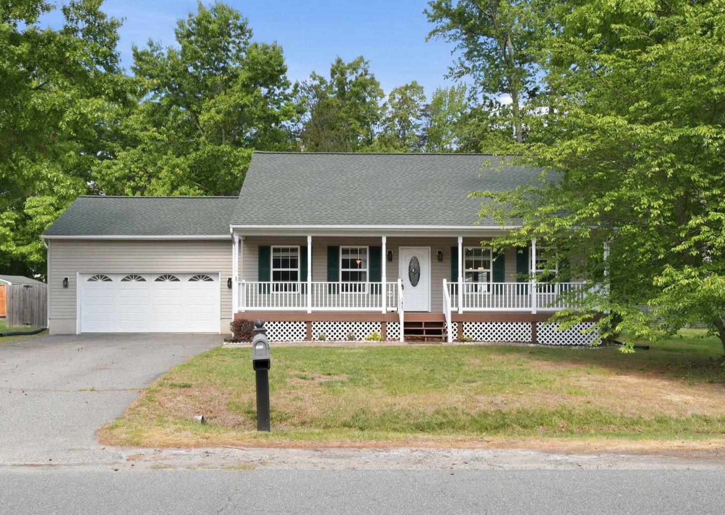 Charming Cape Cod with inviting porch.