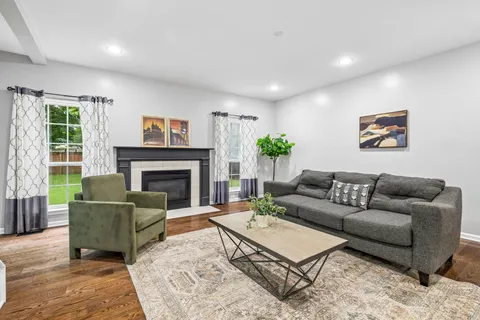 a living room with furniture and a fireplace