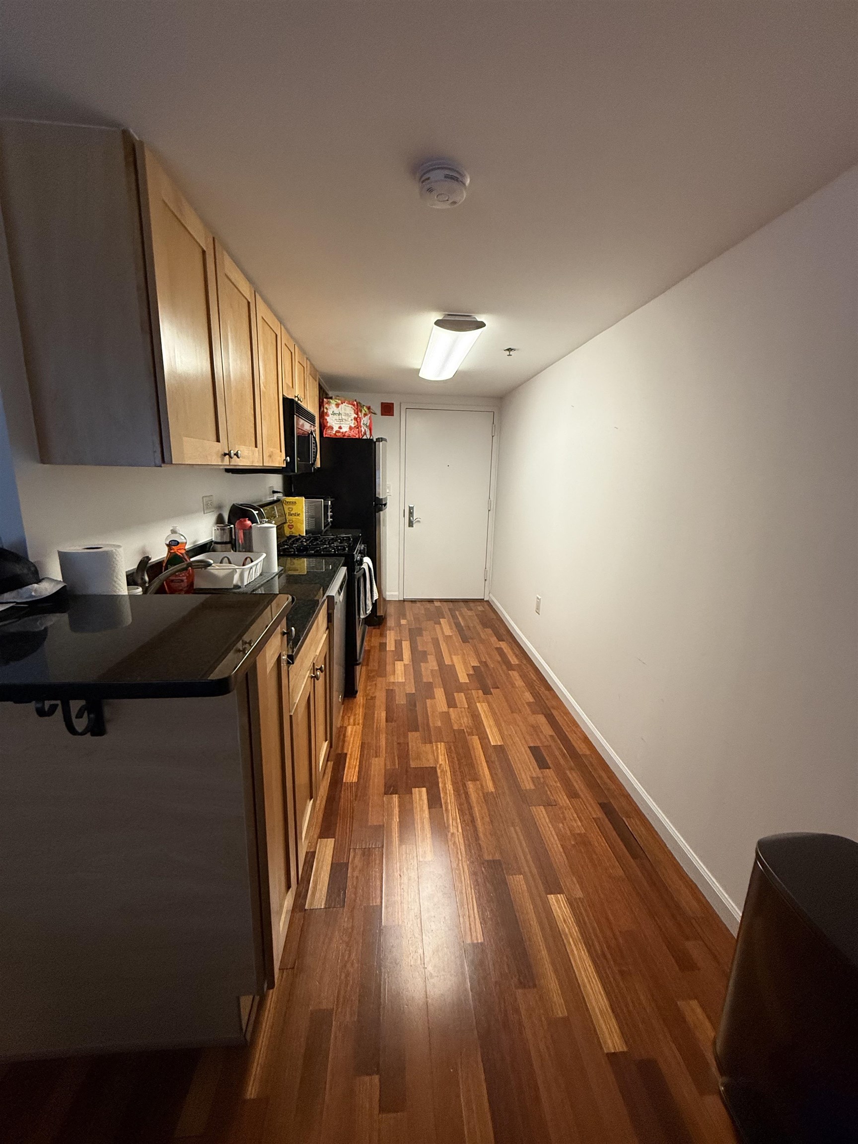 700 1st Street, Unit 2R Hoboken, NJ 07030 - Photo 5 of 13 a hallway with wooden floor and cabinets