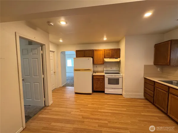 a kitchen with stainless steel appliances a refrigerator and a stove top oven