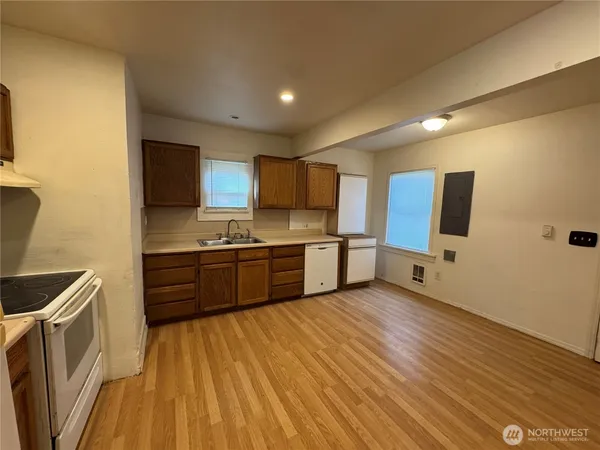 a kitchen with stainless steel appliances kitchen island granite countertop a stove a sink and a refrigerator