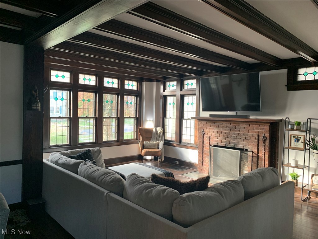 1509 Rydalmount Road Cleveland Heights, OH 44118 - Photo 2 of 12 Living room with baseboards, a fireplace, wood finished floors, and beam ceiling